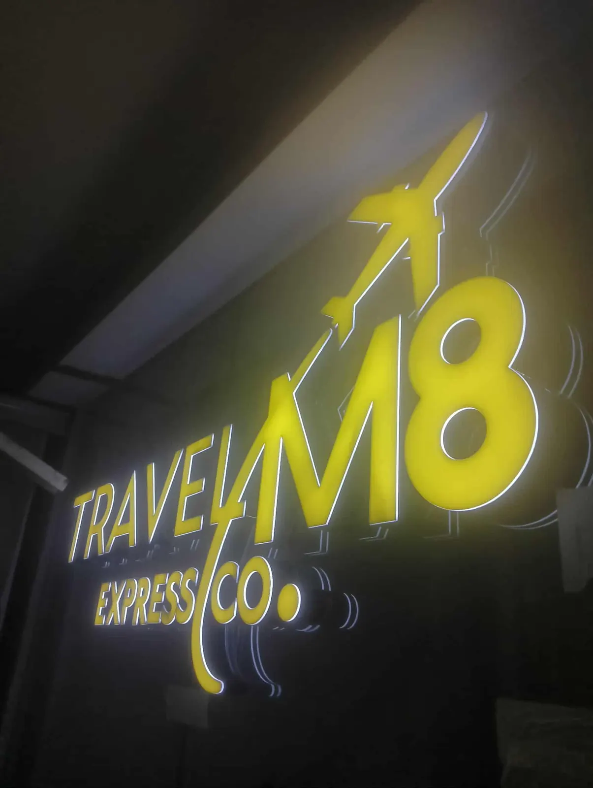 Travel M8 - Yellow halo-lit logo sign